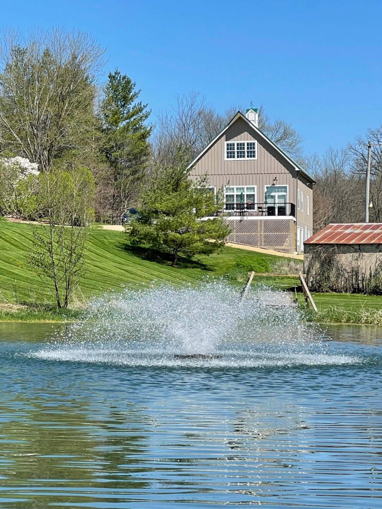 The fountain and pond with the Cording Event Barn in the Background